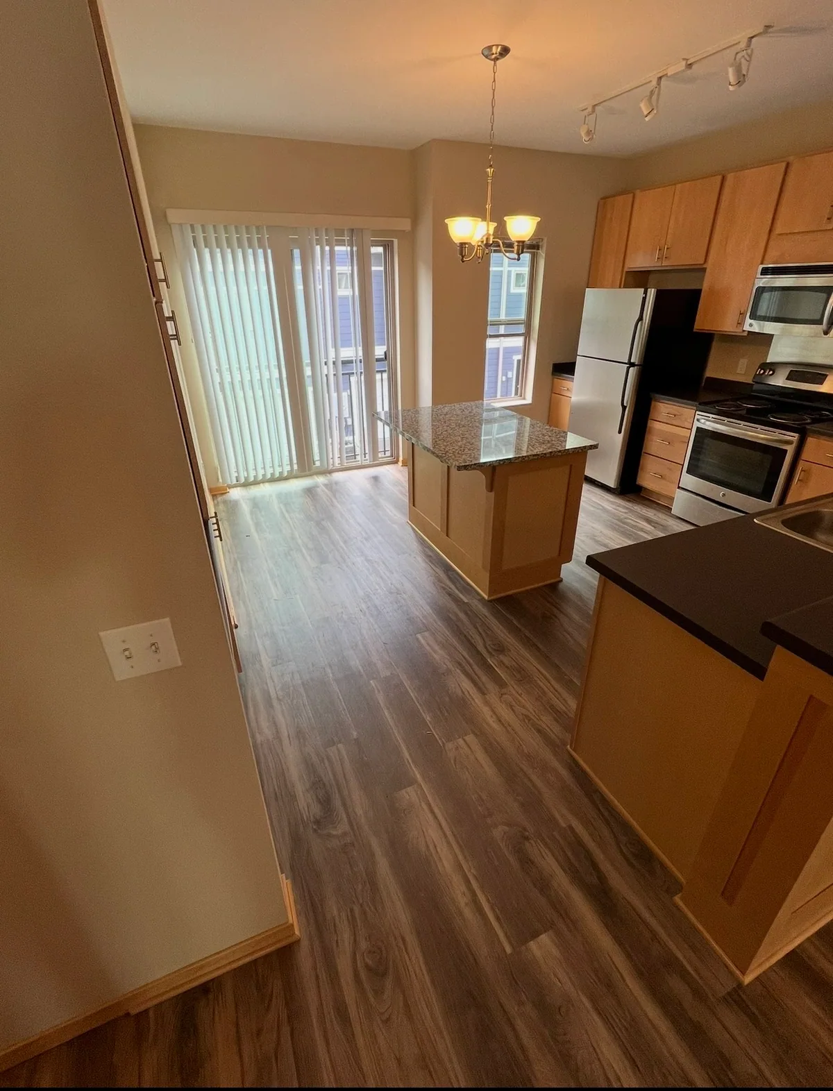 Plank flooring around a kitchen island and into the dining area