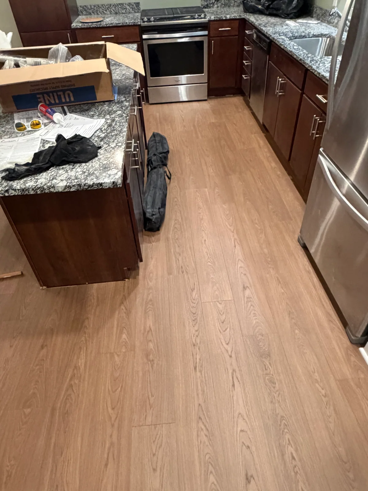 Plank flooring extending through a kitchen